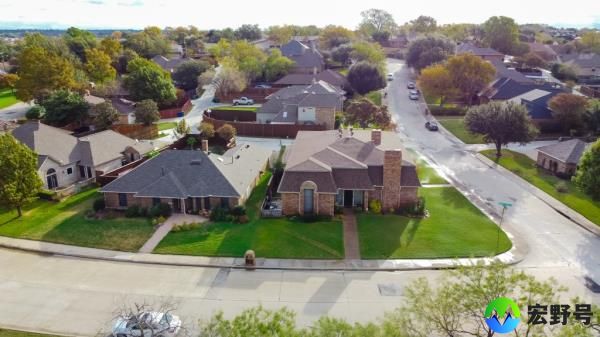 Top view parkside residential houses with large backyard in Carrollton, Texas. Aerial over a typical single family houses with matured trees and fall foliages in suburbs Dallas