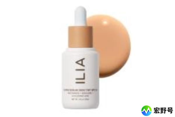 A white bottle of ILIA SPF 40 with a dropper next to a tan circle