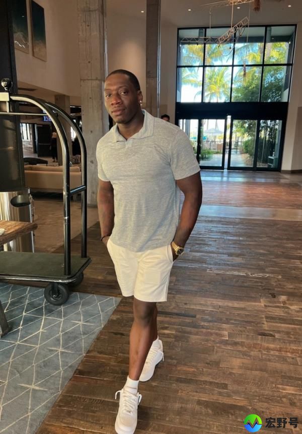 Kirk Walker wearing a gray polo and white senakers