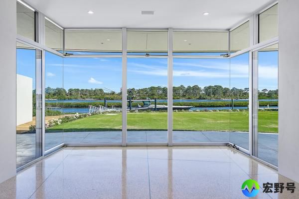 The property features floor-to-ceiling windows throughout.
