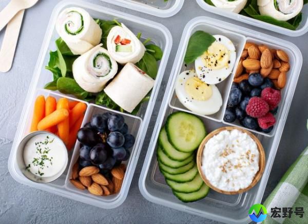 high protein snack or lunch box with cottage cheese cucumbers almo<em></em>nds berries hard boiled egg turkey wraps carrots and ranch