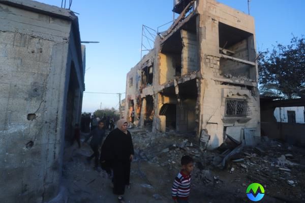 Palestinians walk through the rubble left behind by an Israeli airstrike in Rafah. 
