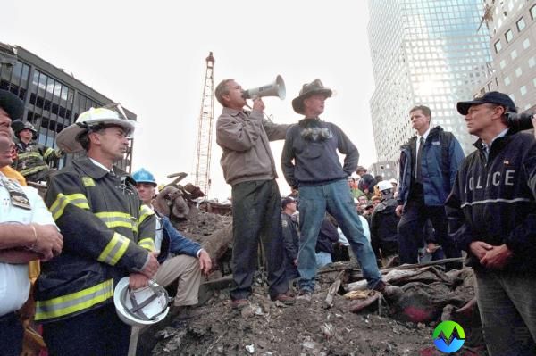 Bush speaks to rescue workers, firefighters and police officers from the rubble of Ground Zero September 14, 2001 in New York City. 