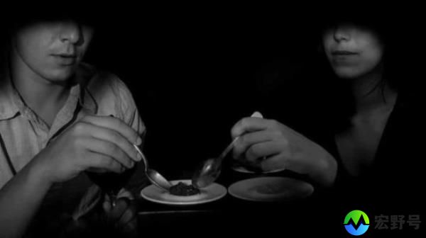 Two people dining in the dark.