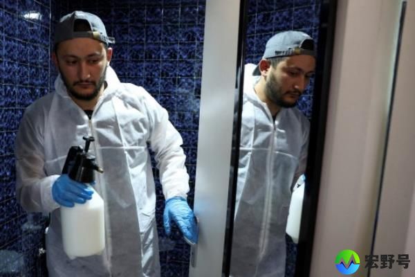 Salim Dahou, biocide technician from the company Hygiene Premium, comes out of the bathroom after preparing the insecticide against bedbugs in L