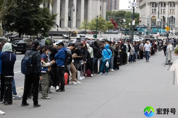 Migrants wait to go into 26 Federal Plaza in Manhattan, Thursday, Aug. 24, 2023.