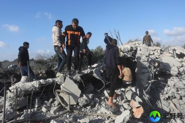 Palestinians search for survivors after a residential building in Rafah was demolished by an Israeli airstrike. 