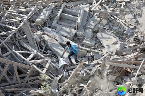 Palestinians walk through the rubble of the destroyed Gaza City. 