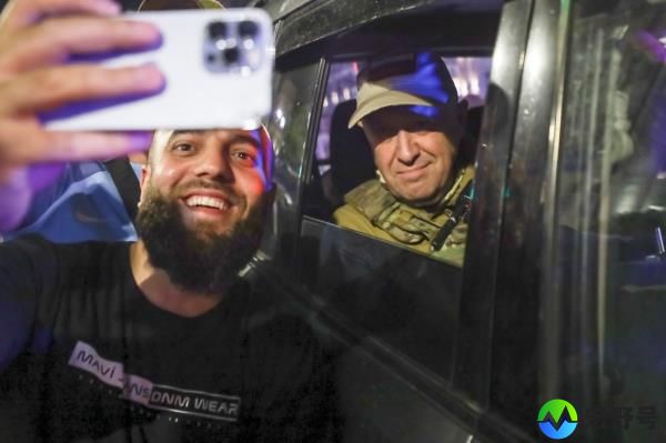 Yevgeny Prigozhin poses for a selfie with an admirer before leaving Rostov-on-Don