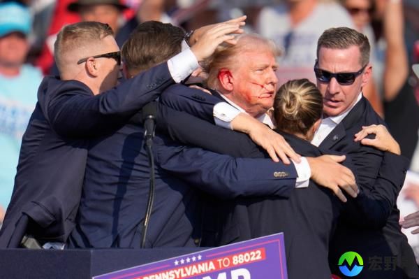 Do<em></em>nald Trump is surrounded by U.S. Secret Service agents as he is helped off the stage at a campaign rally in Butler, Pa., July 13, 2024. 