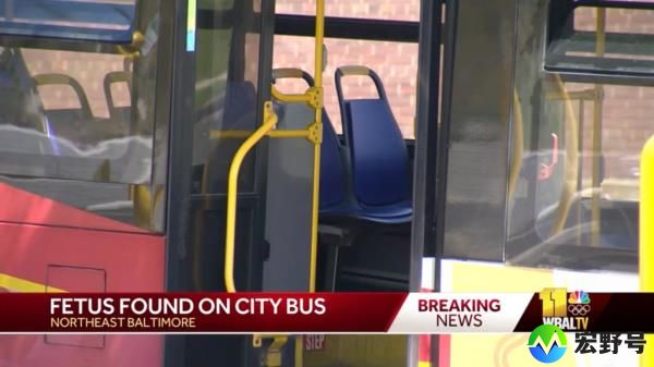 An empty MTA bus with blue seats at the 2500 block of Kirk Avenue in Baltimore, site of a police investigation