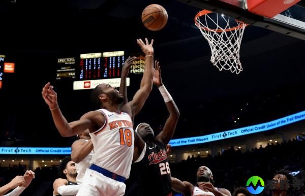 Knicks guard Alec Burks (18) shoots over Portland Trail Blazers center Duop Reath (26) during the first half.