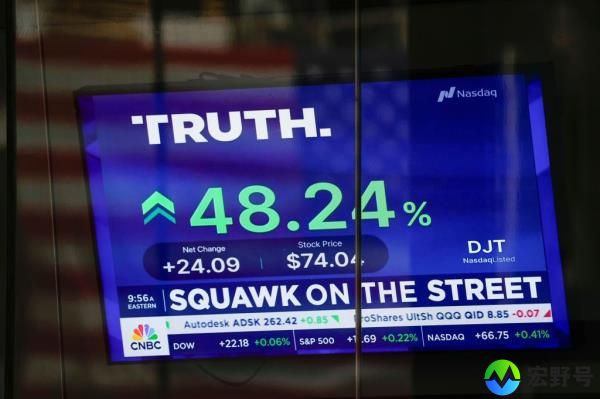 Truth Social stock price displayed on a blue screen with green and white text at the Nasdaq building in New York on March 26, 2024.