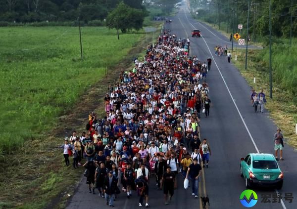 Migrants of different natio<em></em>nalities walk toward the U.S. in a caravan along a road, in Ciudad Hidalgo, Chiapas state, Mexico July 21, 2024.