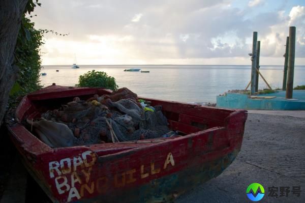 a small fishing boat sits on the seashore in Anguilla, a British overseas territory