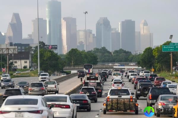 Traffic backed up on a highway approaching Houston, with the city